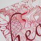 heart written in the middle in red ink, drawing of a biological heart in the background with lots of leaves, dainty patterns, and dotted art, laurateodoriart